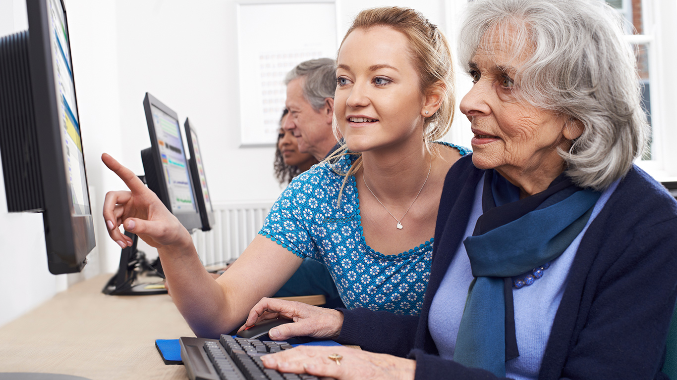 older woman and computer tutor