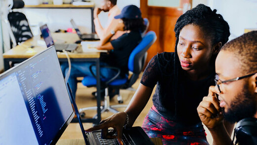 Two people looking at a computer